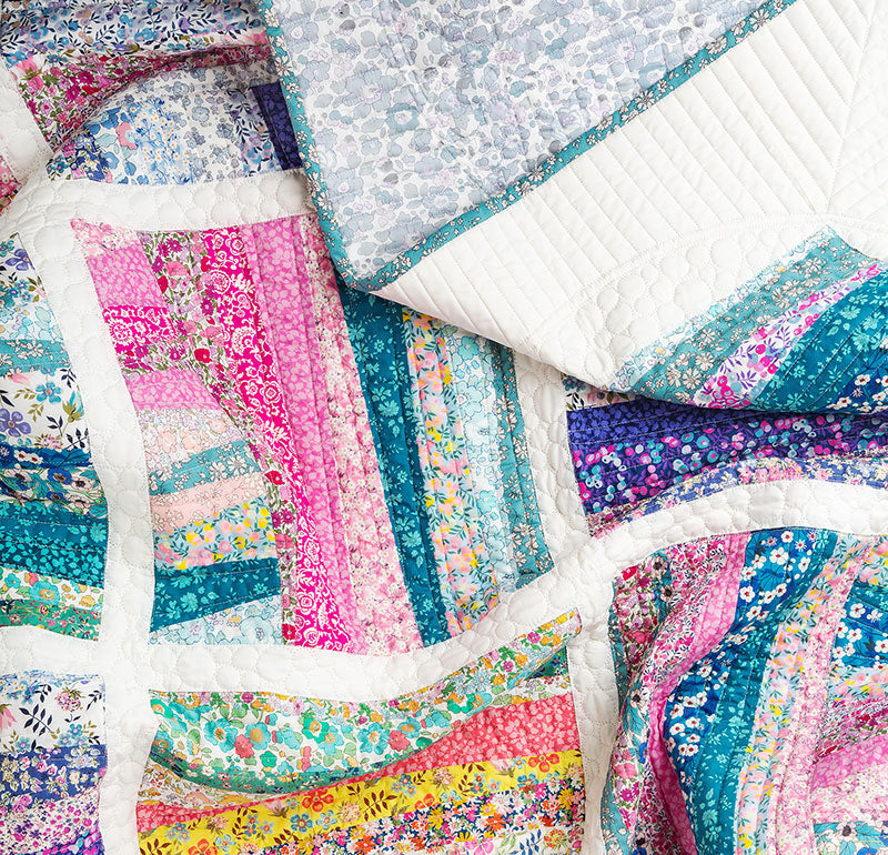 Fabric quilt backing a white background.