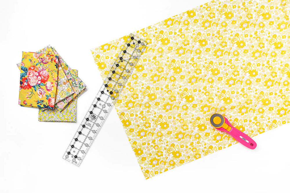 Yellow fabric and a ruler on a white background.